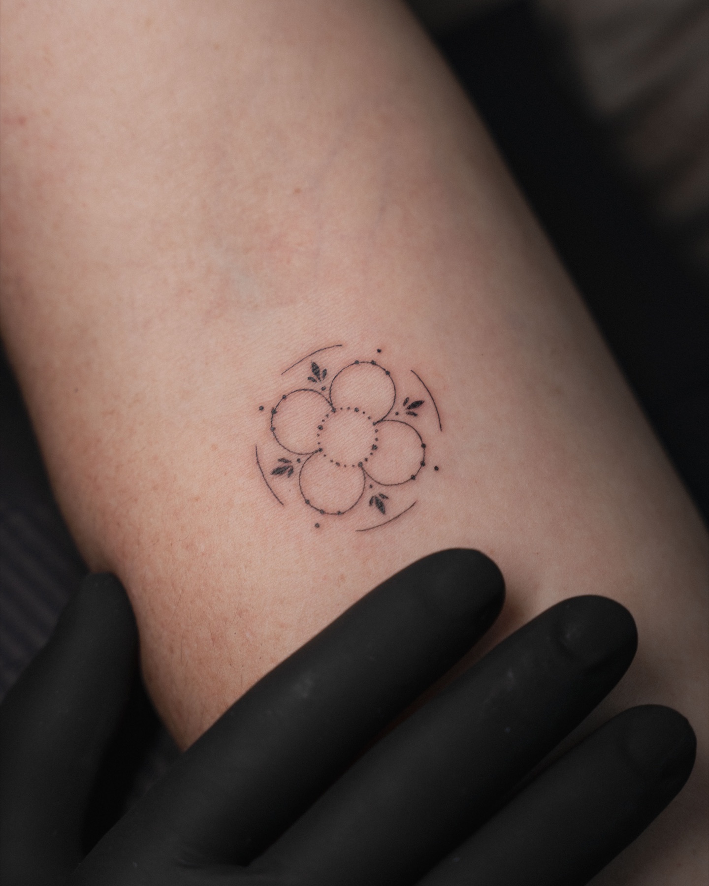 Small geometric flower tattoo